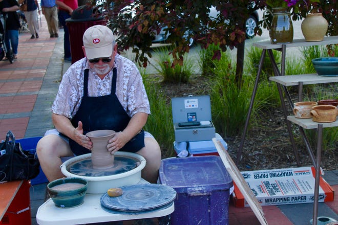 Potter Greg Lamont creates a clay vase during the Art Walk in downtown Ames in June 2017.