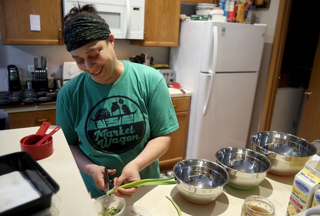 Regina "Reggie" Green, owner of Reggie's Creations, prepares ingredients for a batch of muffins, made with bacon, scallion and cheddar cheese, at her home kitchen in Westerville on May 26. Green is a home baker for Market Wagon Columbus, an online farmers market.