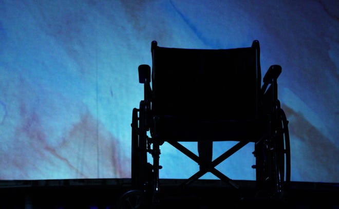 A wheelchair is silhouetted as the lights go down during a scene change during "Wheels," a musical written, musically scored, directed and starring Hardin-Simmons University senior Jess Westman. It opens Thursday.