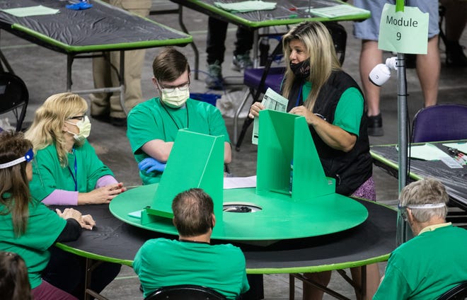 Maricopa County ballots from the 2020 general election are examined and recounted by contractors hired by the Arizona Senate on June 1, 2021, at the Veterans Memorial Coliseum in Phoenix.