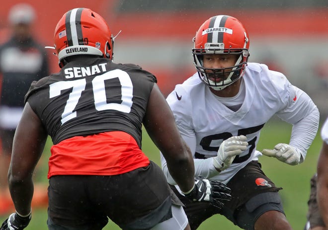 Cleveland Browns defensive end Myles Garrett, facing, stares down offensive tackle Greg Senat during an NFL Football OTA, Wednesday, June 2, 2021, in Berea, Ohio.