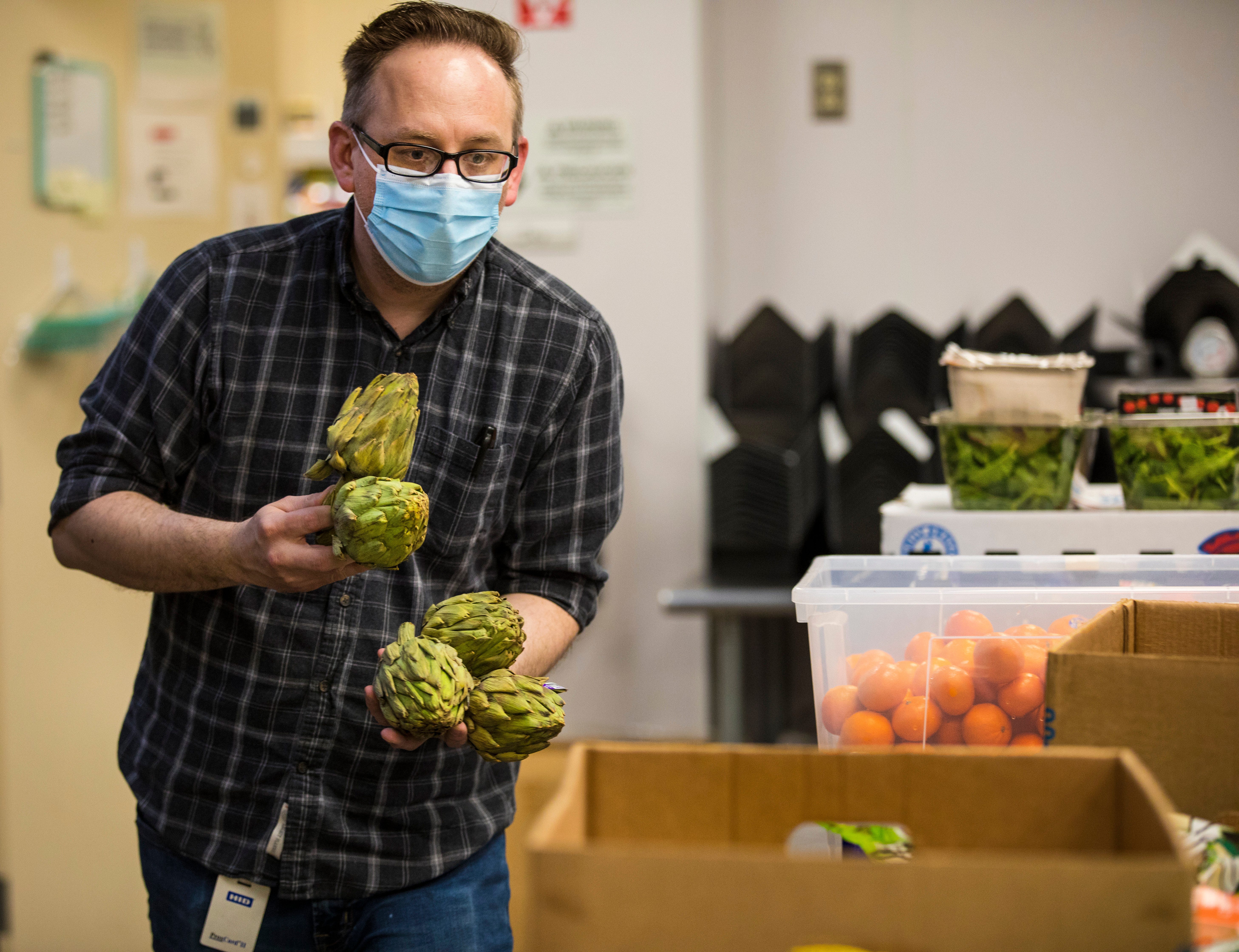 Jay Olzak, food service director at St. Anthony Center, takes the artichokes out of a donation box and immediately starts thinking about how he can prepare them. He thinks about butter, a zest of orange. Olzak is adamant that those who are homeless or struggling still deserve good food.