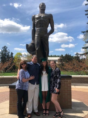 Mark Cramton is pictured with (from left) wife Bridgette and daughters Sarah and Faith after Sarah graduated from Michigan State University.