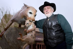 Jerry Miles is photographed in 2004 with one of the first art pieces he and his wife donated to the town of Fountain Hills. The piece is called "Precious Cargo" by Jason Napier.