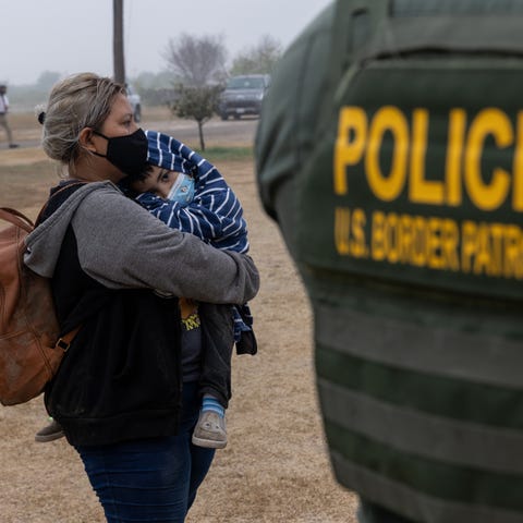 U.S. Border patrol agent and immigrants on April 1
