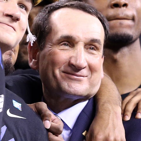 Mike Krzyzewski celebrates with members of Duke's 