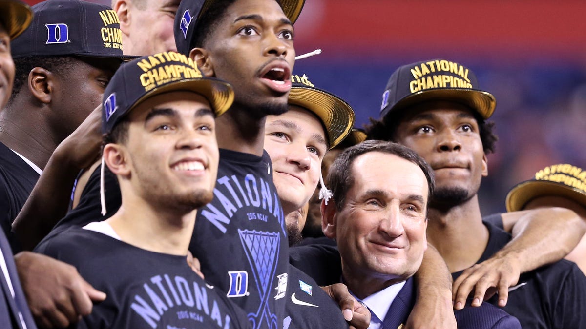 Mike Krzyzewski celebrates with members of Duke's 2015 national title team.
