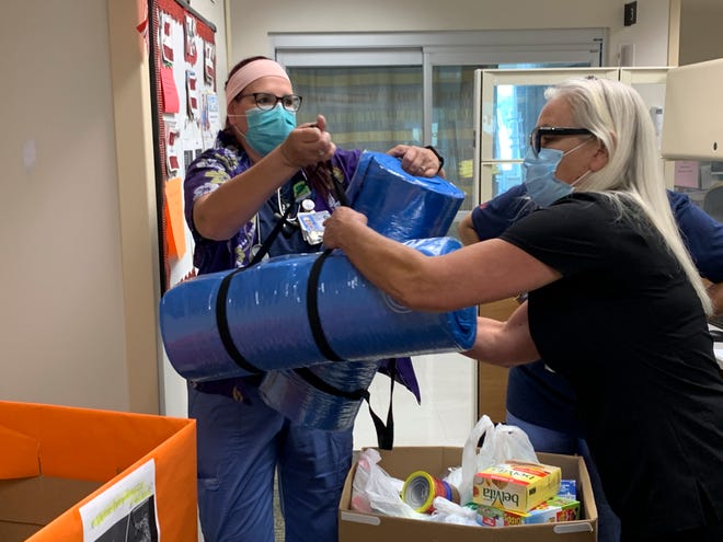 Nurses at the Orlando Health South Lake Hospital in Clermont load the items collected for the Veterans Helping Veterans organization.
