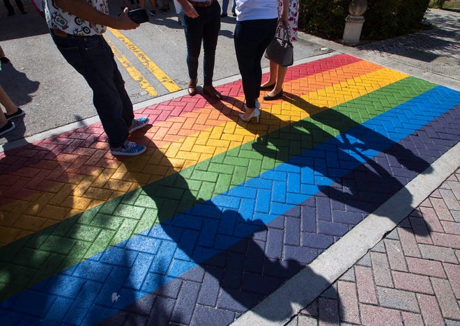 People gather for photographs after the ceremony for new rainbow-colored crosswalks in Northwood Village in West Palm Beach Thursday, June 3, 2021. The rainbow colors, a symbol of LGBTQ pride, are consistent with Mayor Keith James' vision of West Palm Beach as a community of opportunity for all, whereby anyone can achieve their dreams in our city.
