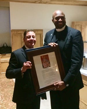 Artist Joseph Chavez presented a gift to Rev. Dr. Turner of the Historic Vernon AME Church after an Ecumenical Prayer Service in the remembrance of the 1921 Tulsa Race Massacre at Holy Family Cathedral on Sunday, May 30, 2021.