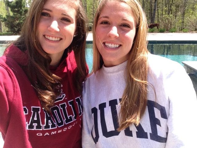 Morgan Rodgers, right, and her twin sister Aberle pose together in a family photograph.