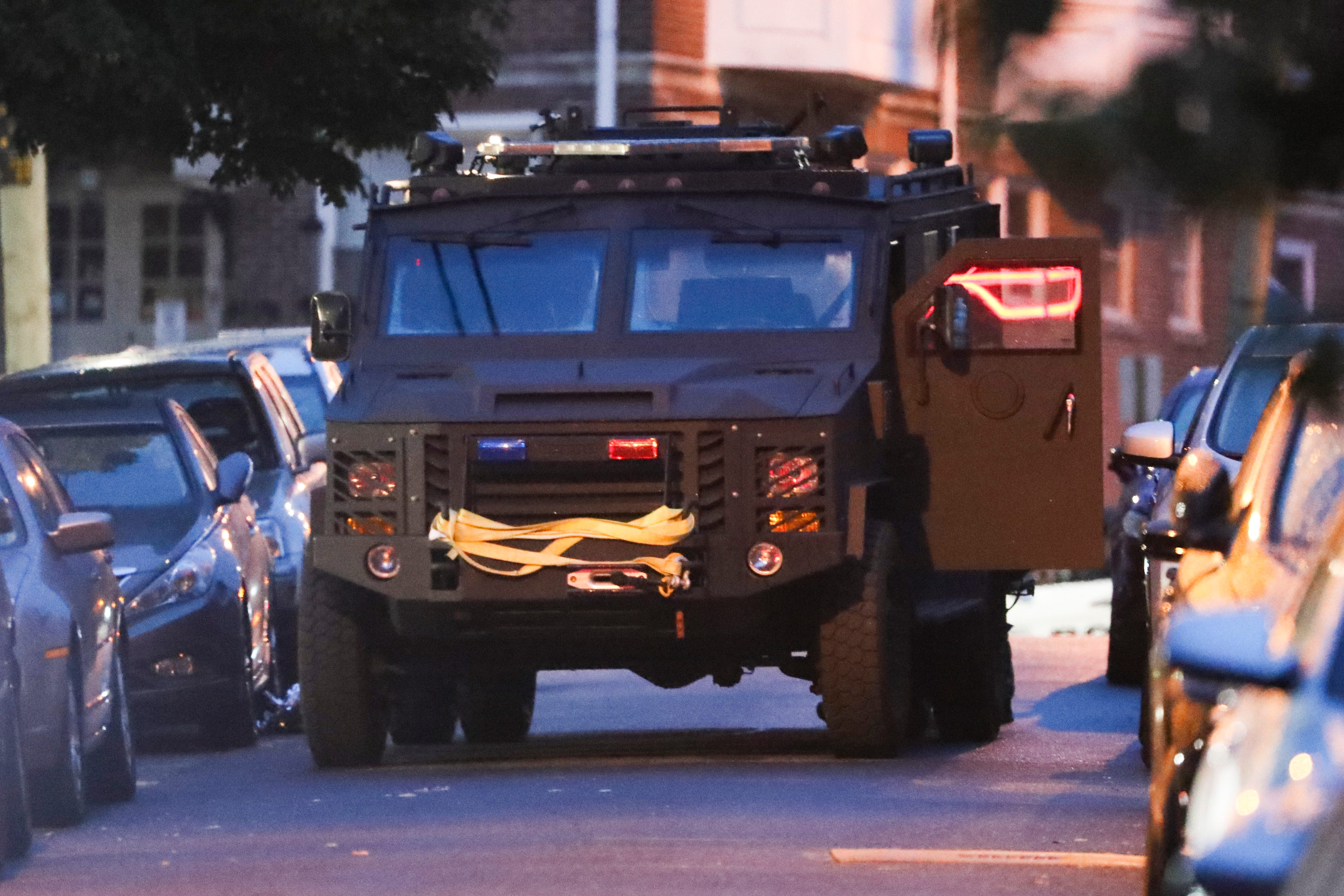 An armored vehicle sits on 25th Street as dawn approaches early Thursday, June 3, 2021 outside the apartment building where three Wilmington police officers were shot in the 2400 block of Market Street late the night before.