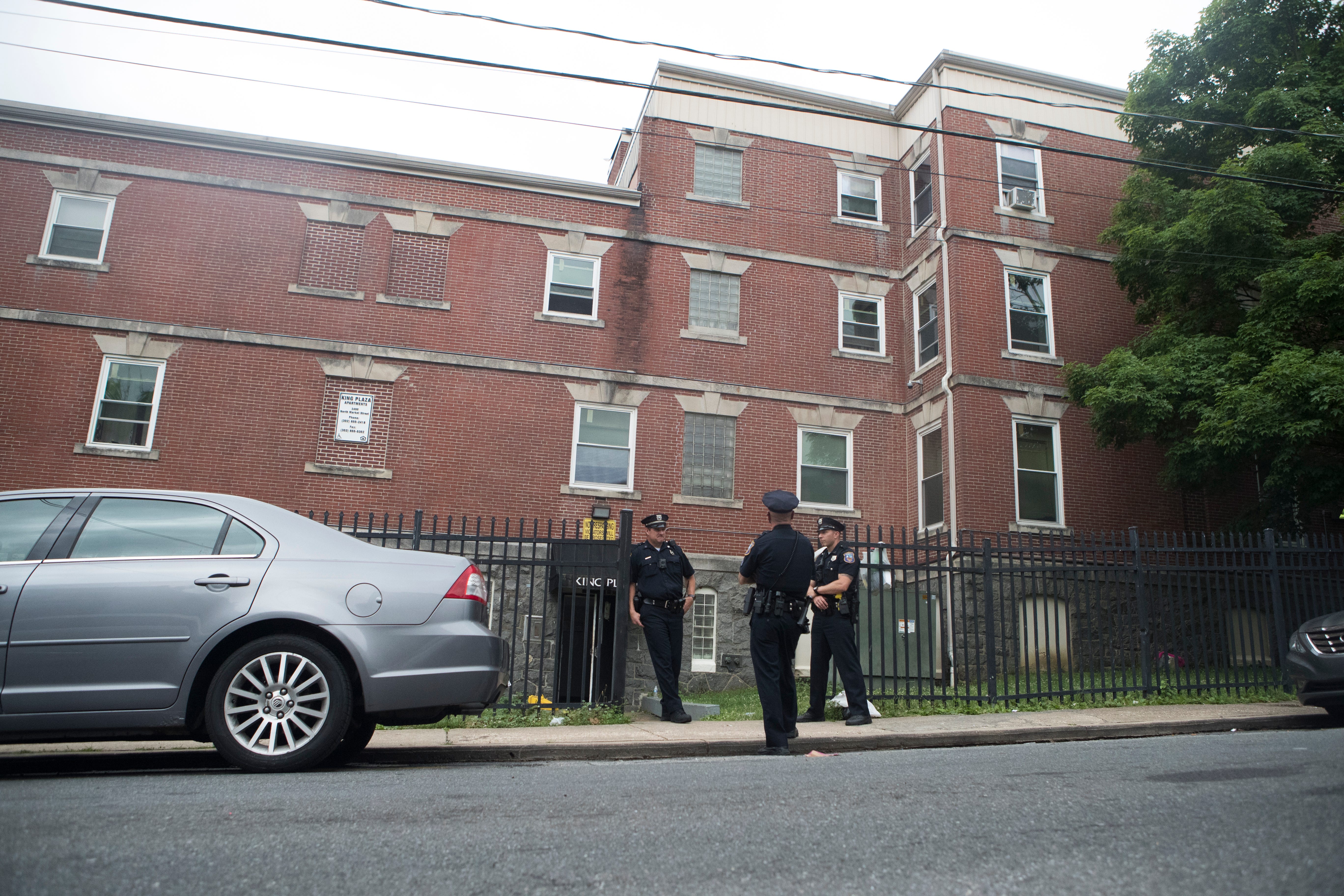 Wilmington Police officers stand outside the site where where three Wilmington Police officers were shot in the 2400 block of Market Street Thursday, June 3, 2021. 