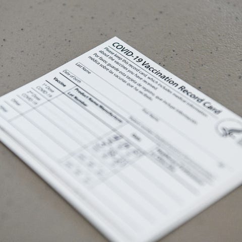 A COVID-19 vaccine record card is seen at Florida 