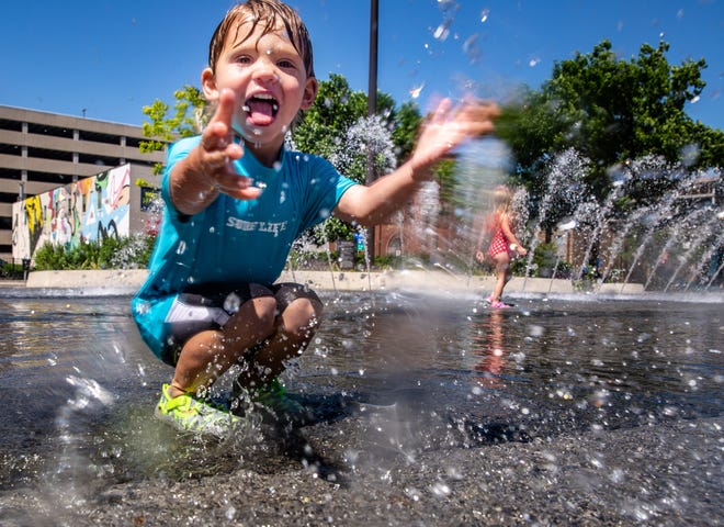 Oliver Backstrom, 2, and his sister Adelyn Backstrom, 3, play in the fountain at Cowles Commons in Des Moines, Friday, June 4, 2021.