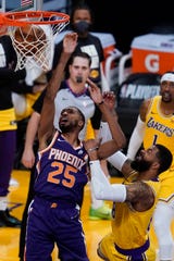 Phoenix Suns forward Mikal Bridges (25) makes a shot against Los Angeles Lakers forward Markieff Morris (88) during the second quarter of Game 6 of an NBA basketball first-round playoff series Thursday, Jun 3, 2021, in Los Angeles. (AP Photo/Ashley Landis)
