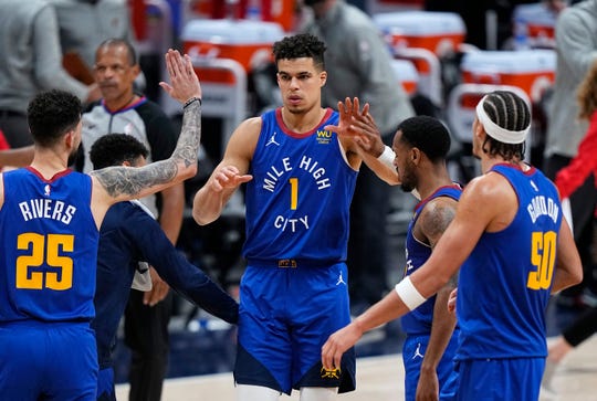Denver Nuggets forward Michael Porter Jr. (1) is congratulated after hitting a 3-point basket against the Portland Trail Blazers in the second overtime during Game 5 of a first-round NBA basketball playoff series Tuesday, June 1, 2021, in Denver. (AP Photo/Jack Dempsey).