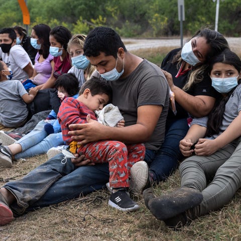 A Guatemalan family waits with fellow immigrants t