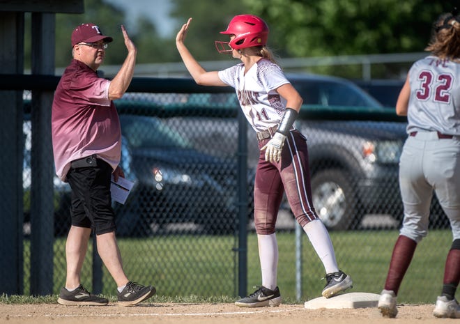 Tremont head coach Brian Patterson high-fives baserunner Anna Parn at third base during their Class 2A Softball Regional title game against the IVC Grey Ghosts on Friday, June 4, 2021 in Tremont.