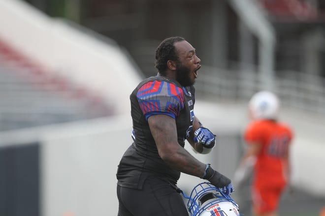 Hutchinson CC linebacker Tre Pinkney celebrates after a big hit on defense as the Blue Dragons defeated the No. 2 Snow College Badgers in the NJCAA national championship 29-27 in Little Rock, Arkansas, Saturday.