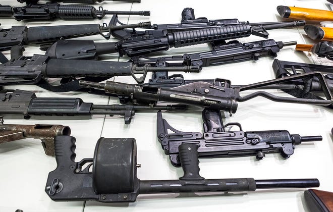 FILE - In this Dec. 27, 2012, file photo are some of the weapons that include handguns, rifles, shotguns and assault weapons, collected in a Los Angeles Gun Buyback event displayed during a news conference at the LAPD headquarters in Los Angeles. A federal judge has overturned California's three-decade-old ban on assault weapons, ruling that it violates the constitutional right to bear arms. U.S. District Judge Roger Benitez of San Diego ruled Friday, June 4, 2021, that the state's definition of illegal military-style rifles unlawfully deprives law-abiding Californians of weapons commonly allowed in most other states. (AP Photo/Damian Dovarganes, File)
