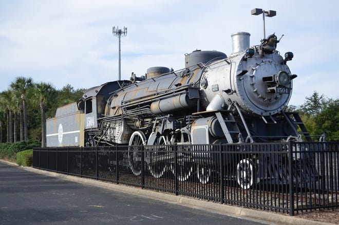 No. 1504, a 101-year-old Atlantic Coast Line locomotive and tender, sits streaked with rust in the early 2000s at the entrance to the Prime Osborn Convention Center's parking lot. It now will be heading elsewhere.
