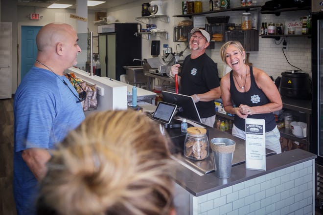 Danny and Makayla Clanton chat with lunchtime customers at their sandwich shop, L-Dub Subs, in Lake Worth Beach on Monday, June 7.