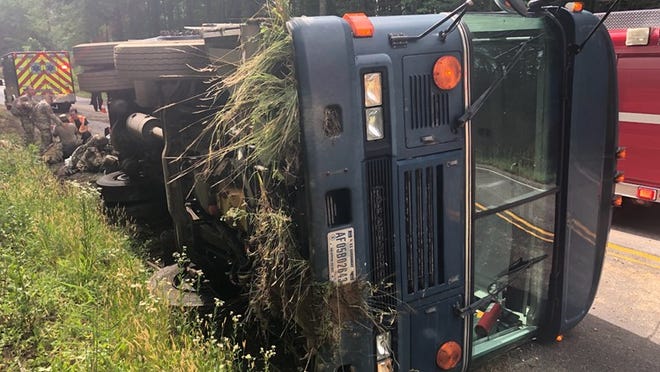 This photo shows a military transport bus that wrecked on state Route 10 in Prince George, Va., Monday, June 7, 2021. The bus was carrying 25 members of the Air National Guard 192nd Security Forces from Joint Base Langley-Eustis in Hampton to Fort Pickett near Blackstone when the accident happened.
