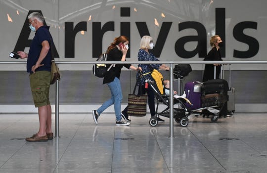 Passengers arrive at Heathrow Airport in London, on June 3, 2021.
