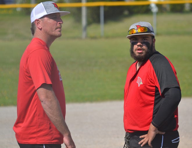 Onaway varsity baseball coach Mike Crull, left, looks on with senior Daniel Price during a game from this past season. After 10 seasons, Crull is stepping down as Onaway's head coach.