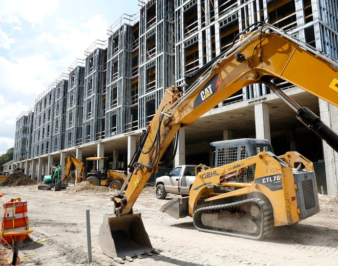 Construction equipment is seen at apartments being built near the University of Florida campus for students.