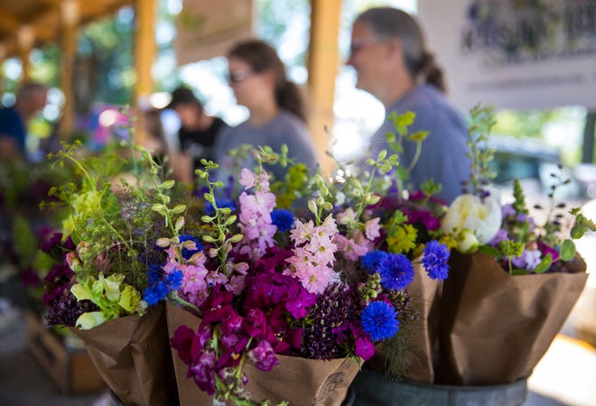 Becky Hartman, the owner of Rusty Bell Farm and Garden in Warren County, sells flowers at the Deerfield Farmers Market. Fresh produce, flowers and other local items are sold at the Deerfield Farmers Market from 9 a.m.-noon every Saturday.