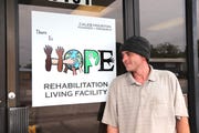 Pensacola man Joshua Davis stands in front of the There Is Hope Rehabilitation Living Center in Pensacola.  Davis received physical and mental care from the facility, including a new job.