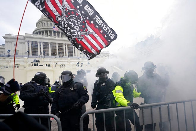 FILE - In this Jan. 6, 2021, U.S. Capitol Police officers hold off rioters loyal to President Donald Trump at the Capitol in Washington. (AP Photo/Julio Cortez, File)