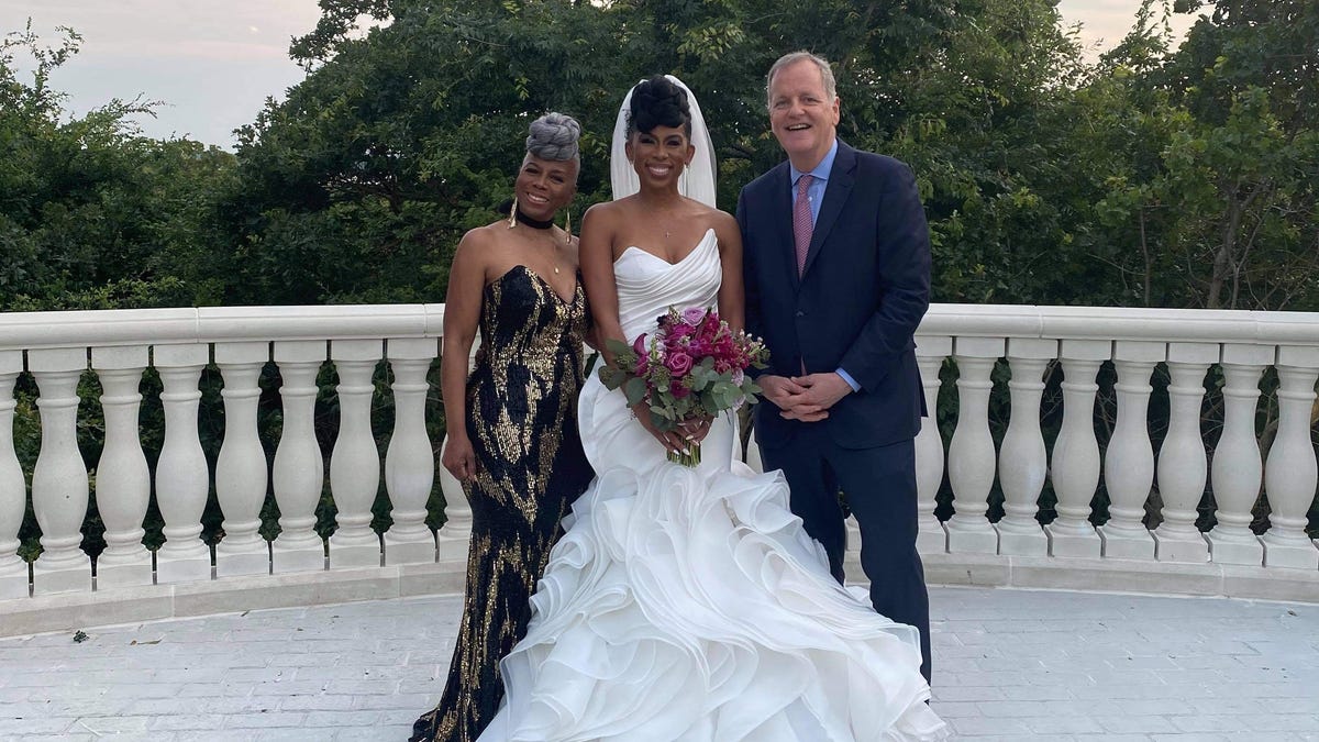 Southwest Airlines flight attendant JacqueRae Sullivan is flanked by American Airlines CEO Doug Parker and her mother, Patti Anderson, at Sullivan's wedding on May 30. Parker and Sullivan met on a Southwest flight a year ago and had an emotional talk about race.