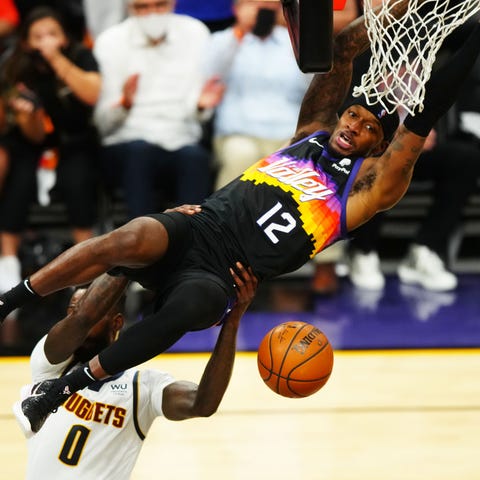 The Phoenix Suns' Torrey Craig slam dunks the ball