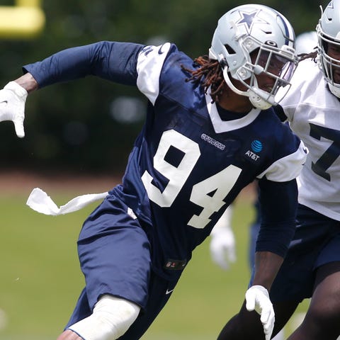 Randy Gregory (94) goes through drills against off