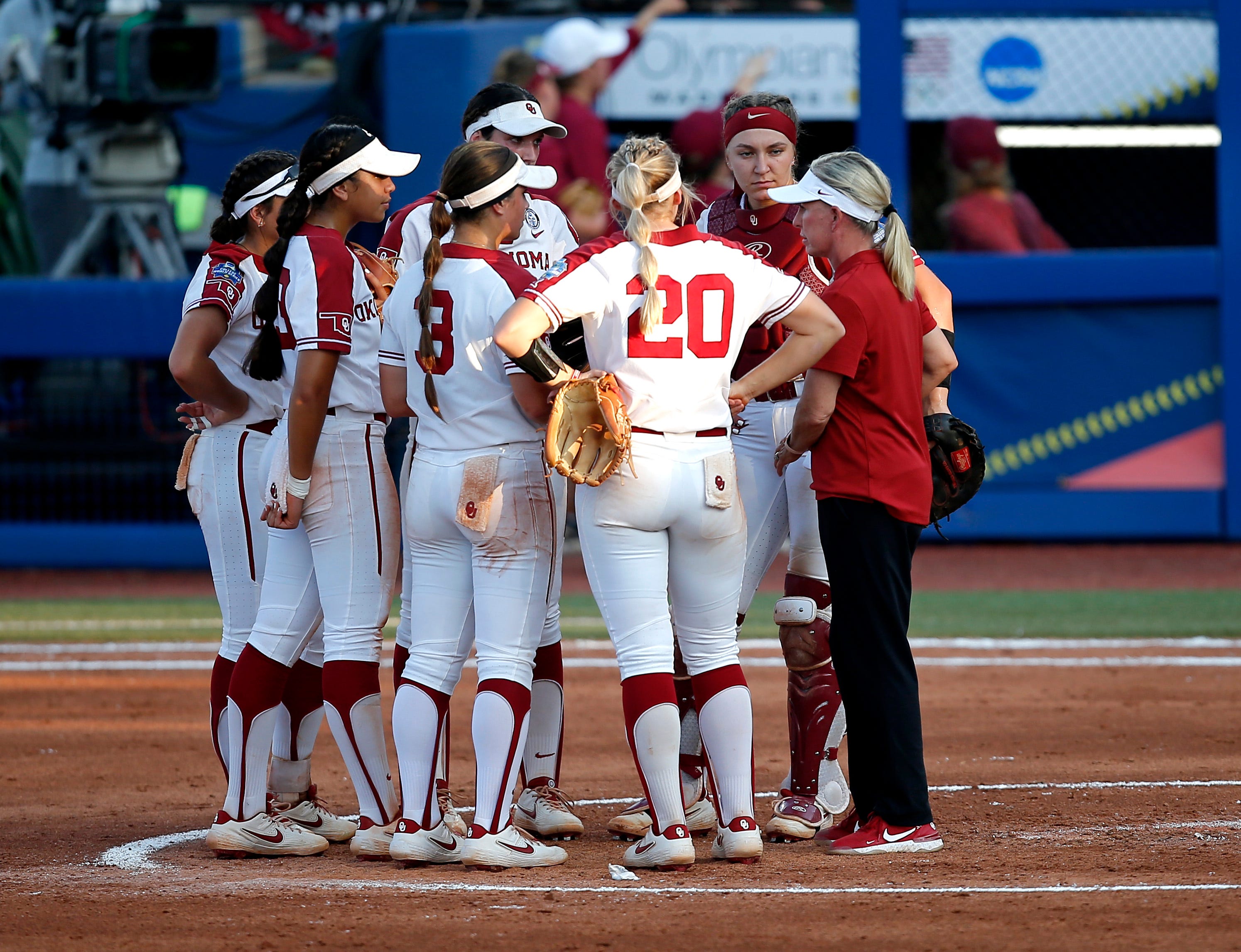 Oklahoma head coach Patty Gasso talks with her team during a time out during the first game of Women's College World Series championship series between University of Oklahoma (OU) and Florida State University at the USA Softball Hall of Fame Stadium in Oklahoma City, Tuesday, June 8, 2021.