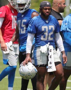 Lions running back D'Andre Swift takes a break during minicamp practice on Wednesday, June 9, 2021, at the Allen Park practice facility.
