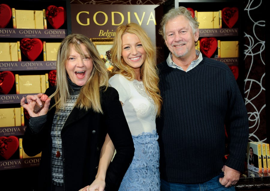 Actress Blake Lively, center, poses with her parents Elaine and Ernie Lively at a Godiva press event on Wednesday, Feb. 1, 2012 in New York.