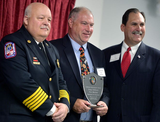 Retired Hagerstown Fire Marshal Doug DeHaven, center, poses for a photo with Hagerstown Fire Department Fire Chief Steve Lohr, left, and Paul Frey, president and CEO of the Washington County Chamber of Commerce, after receiving the lifetime achievement award at the Washington County Public Safety Awards Thursday held at the Community Volunteer Fire Company of District 12 in Fairplay. 