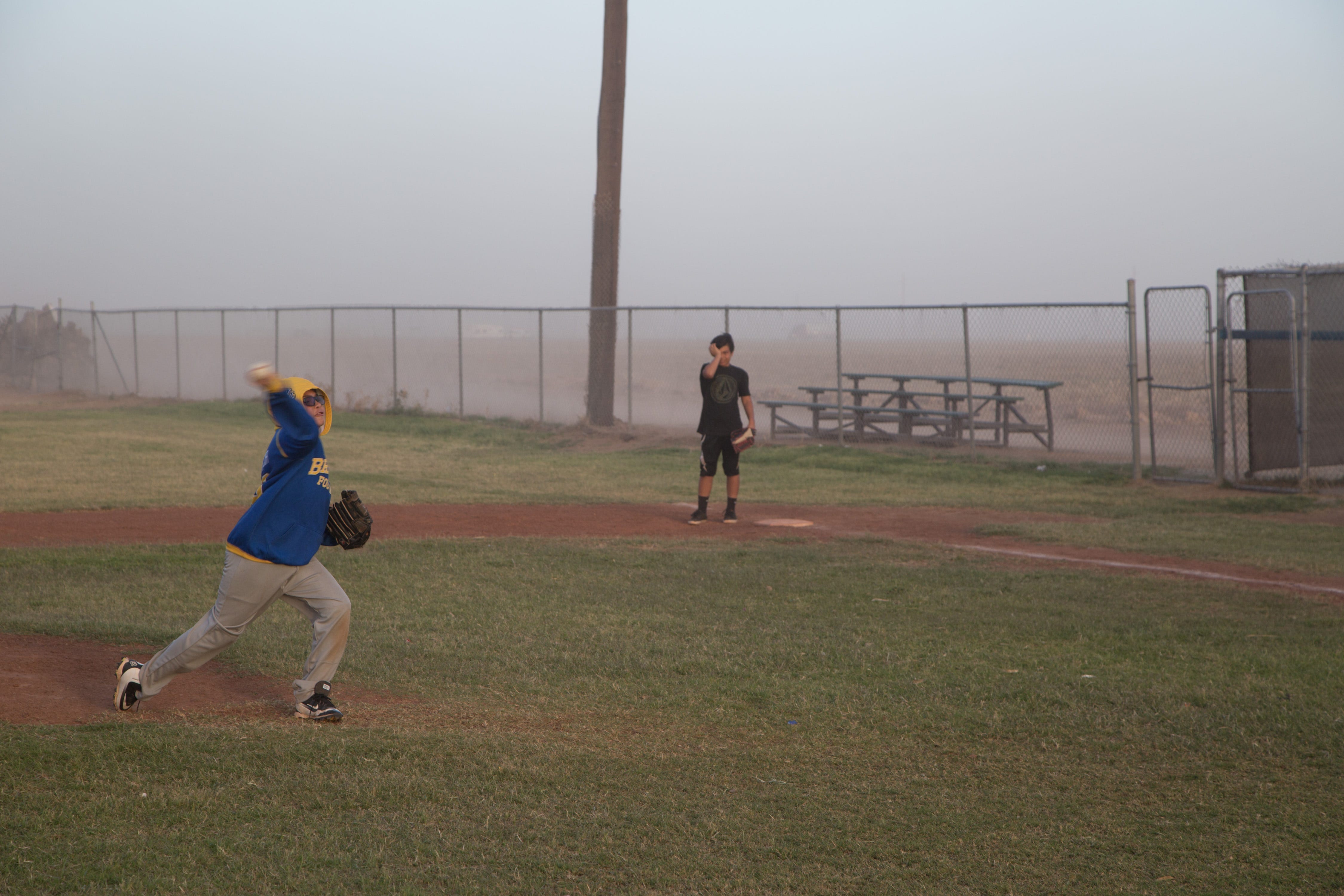 Kids play baseball during a dust storm in Westmorland, Calif., on March 30, 2017.