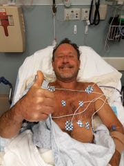 Lobster diver Michael Packard, 56, of Wellfleet, gives the thumbs up Friday morning from Cape Cod Hospital in Hyannis, where he was taken after he was injured in an encounter with a humpback whale Provincetown. He was later released from the hospital.