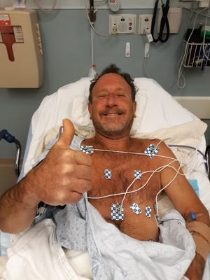 Lobster diver Michael Packard, 56, of Wellfleet, gives the thumbs up Friday morning from Cape Cod Hospital in Hyannis, where he was taken after he was injured in an encounter with a humpback whale Provincetown. He was later released from the hospital.