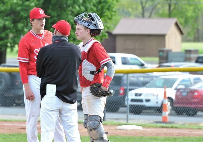 Shelby's Marshall Shepherd talks thinks over with head coach Jon Amicone and catcher Blaine Bowman during a game at Clear Fork. Shepherd was named the 2021 Mansfield News Journal Baseball Pitcher of the Year.