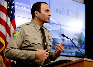 Maricopa County Sheriff Paul Penzone speaks at a news conference in Phoenix on 14, 2019. The taxpayer costs for the racial profiling lawsuit stemming from immigration patrols launched a decade ago by Penzone's predecessor, six-term Sheriff Joe Arpaio, are expected to reach $202 million by the summer of 2022.