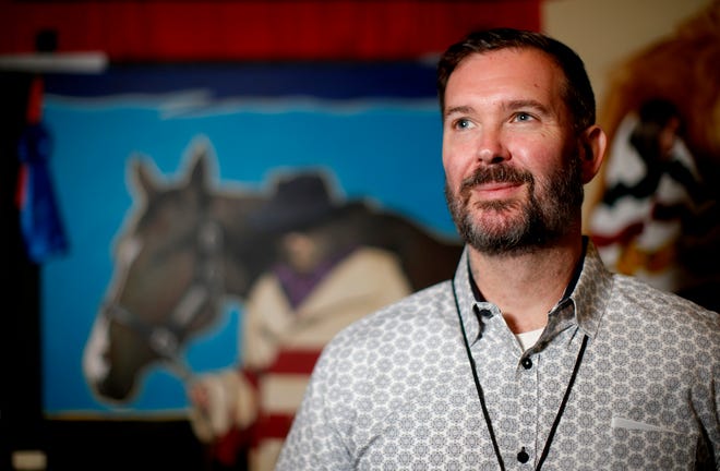 Choctaw artist Dylan Cavin is seen at his booth Saturday during the Red Earth Festival.