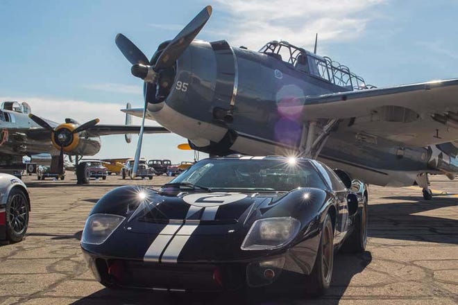 Arranged on the ramp of the Yankee Air Museum, the exhibit includes the event’s “poster car” Darrin Packard — a well as rare planes like the single-seat Douglas AD-1 Skyraider and a Grumman C-1 Trader cargo plane.