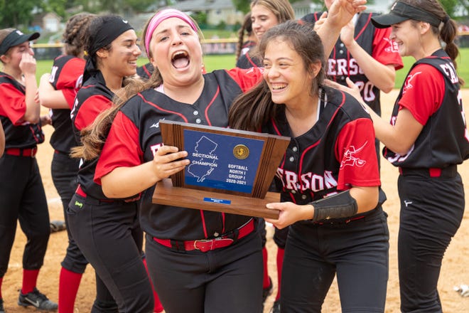 Emerson seniors Ashlyn Sterinsky (left) and Amanda Sallemi brandish the trophy after the Cavos won the North 1, Group 1 softball sectional title in Emerson, N.J. on Saturday, June 12, 2021.
