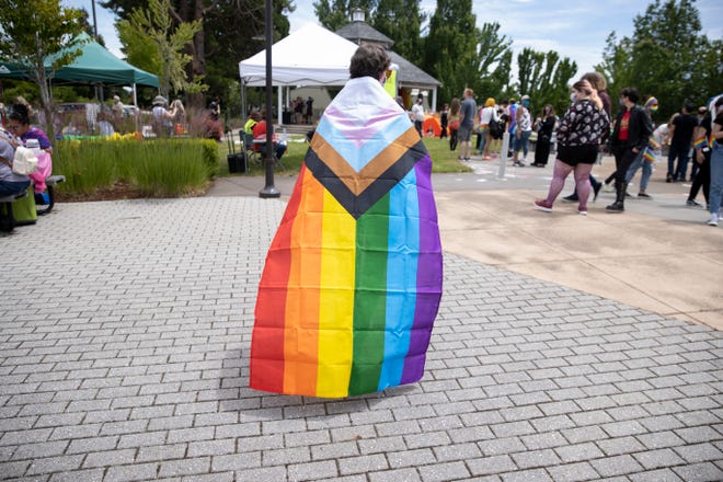 Community members browse booths with resources and products at the Keizer Pride Fair at Chalmers Jones Park in Keizer, Oregon on Saturday, June 12, 2021.